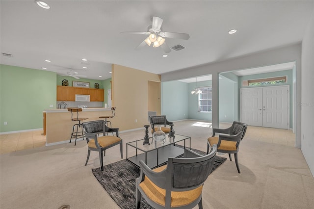 carpeted living room featuring ceiling fan