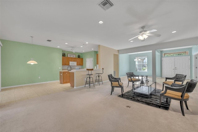 dining room featuring light colored carpet and ceiling fan