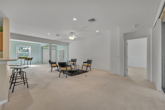 carpeted dining area with ceiling fan