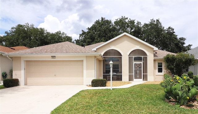 single story home with a garage and a front lawn