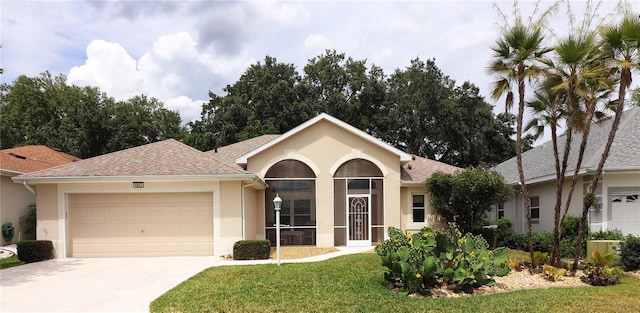 single story home with a garage and a front lawn