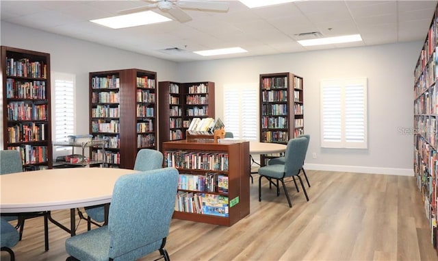 office featuring a paneled ceiling, ceiling fan, and light hardwood / wood-style floors