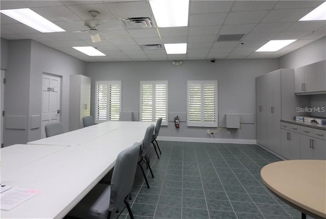 kitchen featuring a paneled ceiling, dark tile patterned floors, and ceiling fan