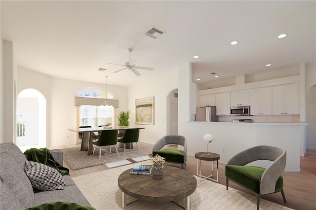 living room featuring ceiling fan and light wood-type flooring