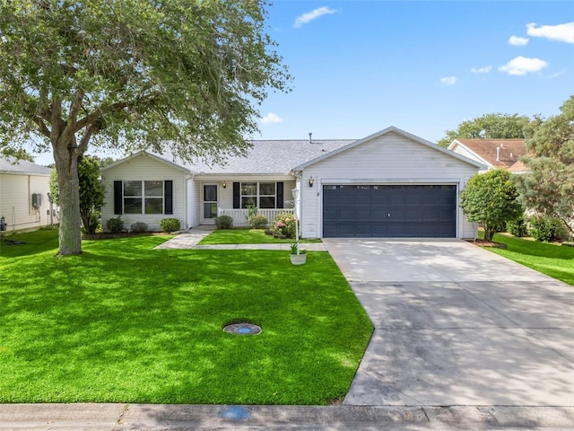 ranch-style house featuring a front yard and a garage