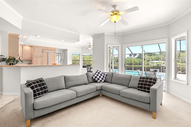 living room featuring light carpet, ceiling fan, and ornamental molding