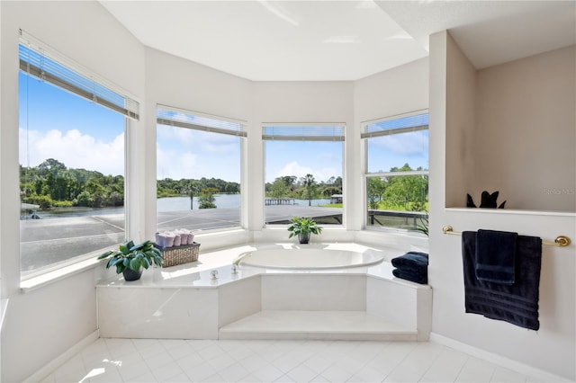 bathroom featuring tile floors, plenty of natural light, and a bathtub