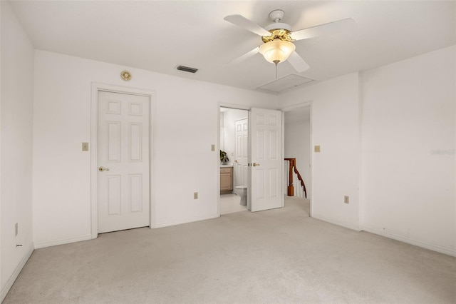 unfurnished bedroom with ensuite bath, ceiling fan, and light carpet