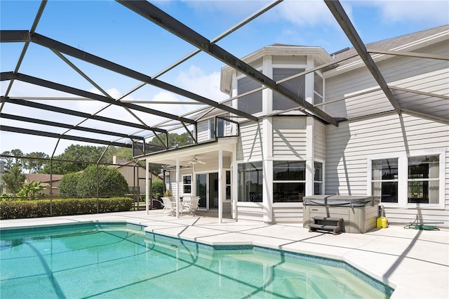 view of pool featuring a hot tub, a lanai, ceiling fan, and a patio area