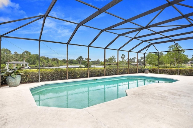 view of swimming pool featuring a patio area and glass enclosure