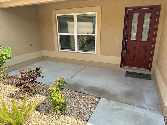 doorway to property with a patio