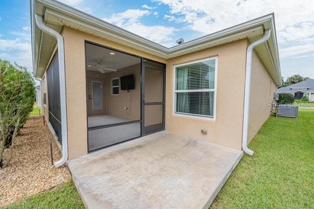 back of house with a patio, a sunroom, and a yard