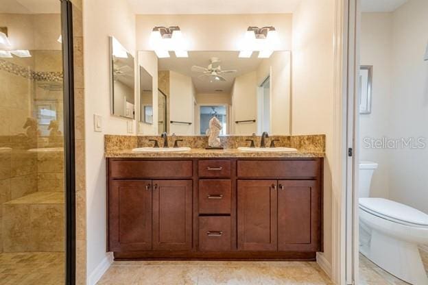 bathroom with vanity, a shower with shower door, and toilet