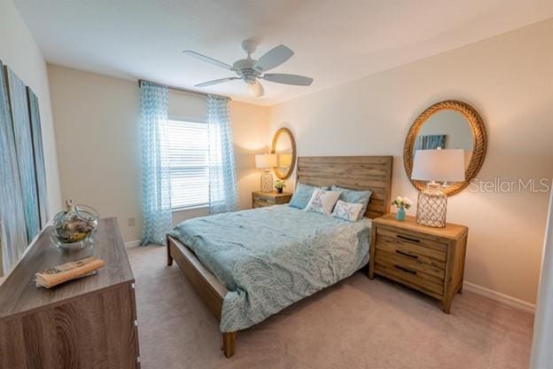 bedroom with ceiling fan and carpet flooring