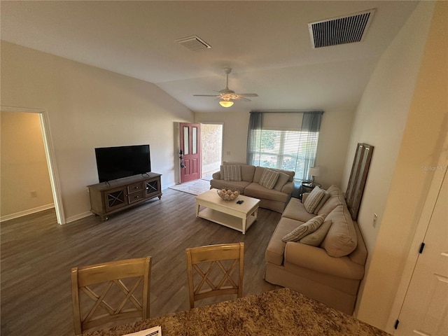 living room featuring dark wood-type flooring, ceiling fan, and vaulted ceiling