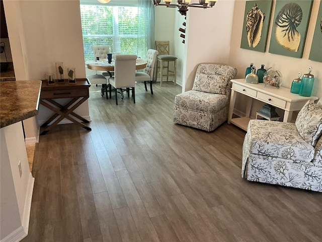 living area with an inviting chandelier and hardwood / wood-style floors