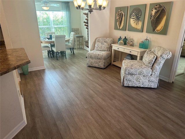 living area featuring dark hardwood / wood-style flooring and a notable chandelier