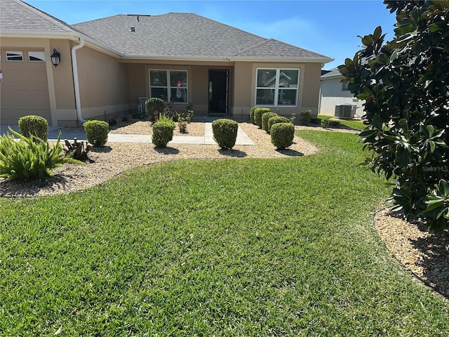 exterior space featuring stucco siding, roof with shingles, central AC unit, and a front yard