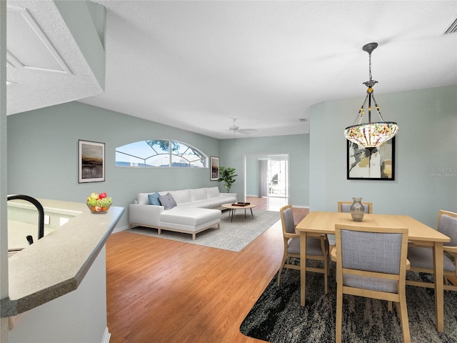 dining space with wood finished floors, visible vents, and baseboards