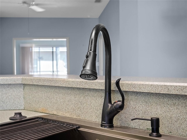 interior details with light countertops and a sink