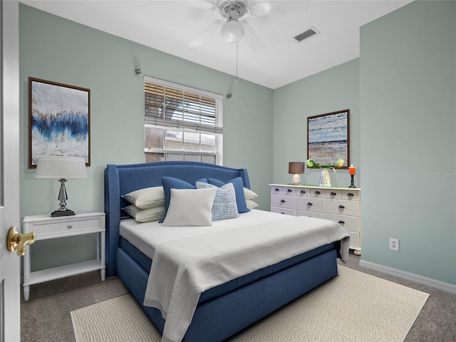 carpeted bedroom with baseboards, visible vents, and a ceiling fan