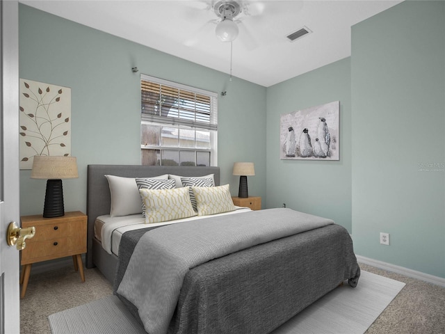 bedroom with a ceiling fan, baseboards, visible vents, and carpet flooring