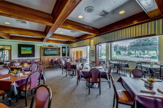 dining room featuring carpet floors, beam ceiling, a healthy amount of sunlight, and coffered ceiling