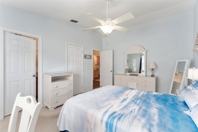 bedroom with ceiling fan, light carpet, and lofted ceiling