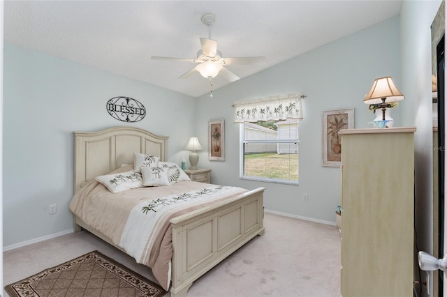 carpeted bedroom with ceiling fan and vaulted ceiling