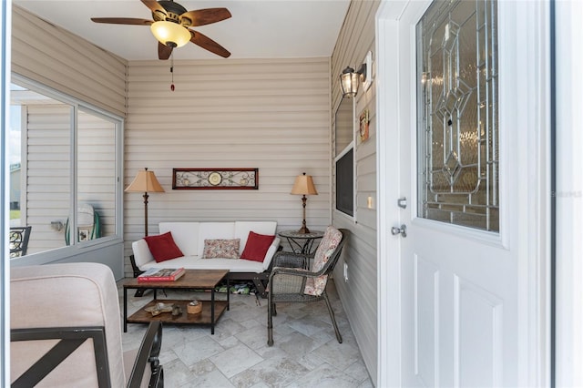 sunroom with ceiling fan