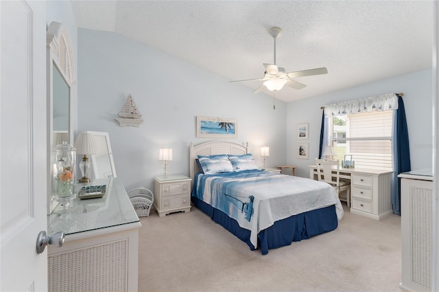 carpeted bedroom featuring ceiling fan, vaulted ceiling, and a textured ceiling