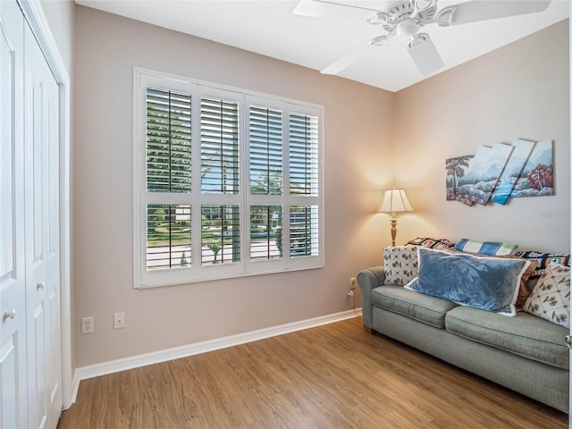 living room featuring ceiling fan and light hardwood / wood-style floors