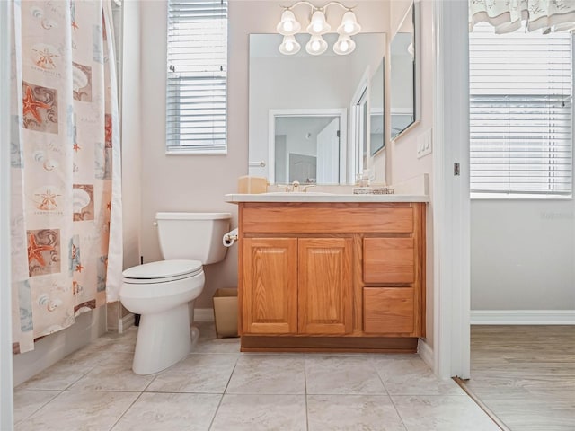 full bathroom with vanity, a healthy amount of sunlight, toilet, and shower / tub combo