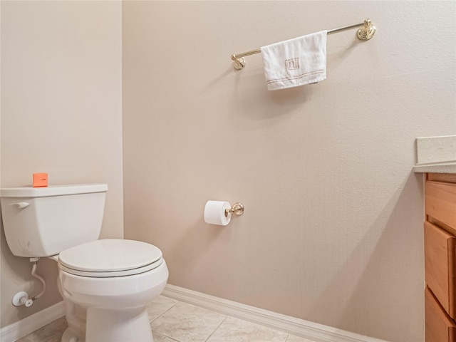 bathroom featuring tile patterned floors, vanity, and toilet