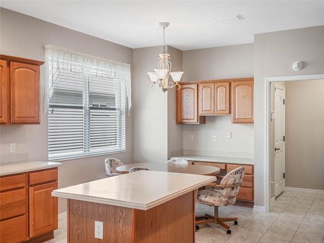 kitchen featuring pendant lighting, a center island, light tile patterned floors, a notable chandelier, and a kitchen bar