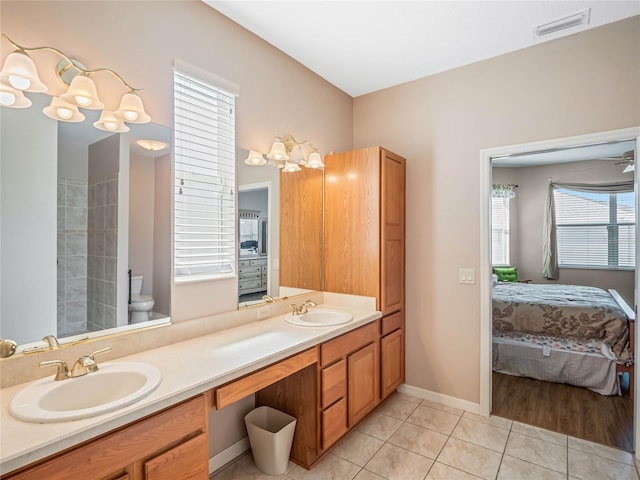 bathroom with tile patterned flooring, vanity, and toilet