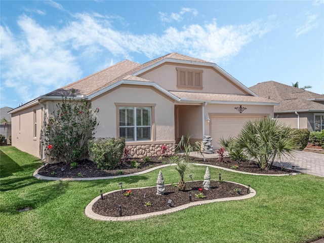 view of front of home featuring a front lawn and a garage