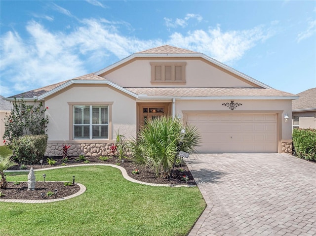 view of front of house with a garage and a front lawn