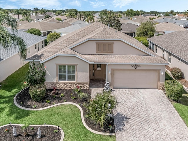 view of front of property featuring a garage and a front lawn