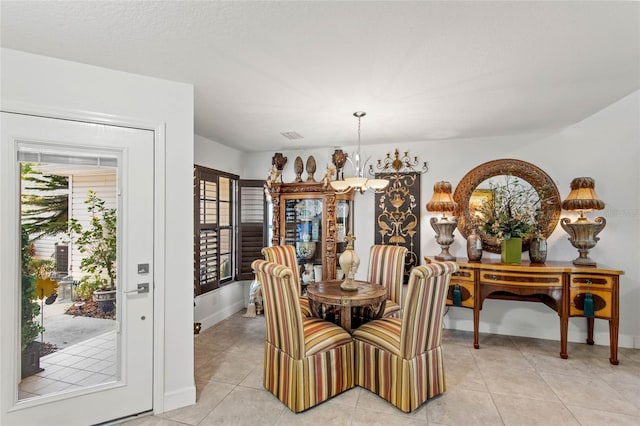 tiled dining area with a notable chandelier