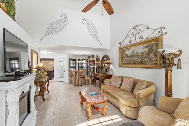 living room with light tile patterned flooring and ceiling fan with notable chandelier