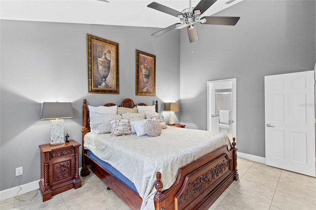 bedroom with lofted ceiling, light tile patterned flooring, ceiling fan, and ensuite bath