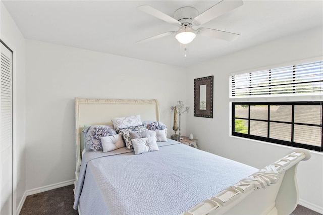 bedroom with ceiling fan and dark colored carpet