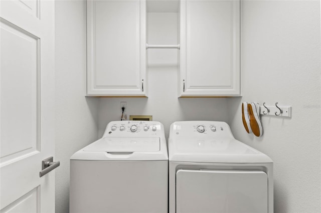 laundry area with cabinets and independent washer and dryer