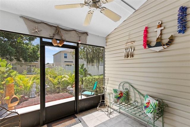 unfurnished sunroom with ceiling fan and vaulted ceiling