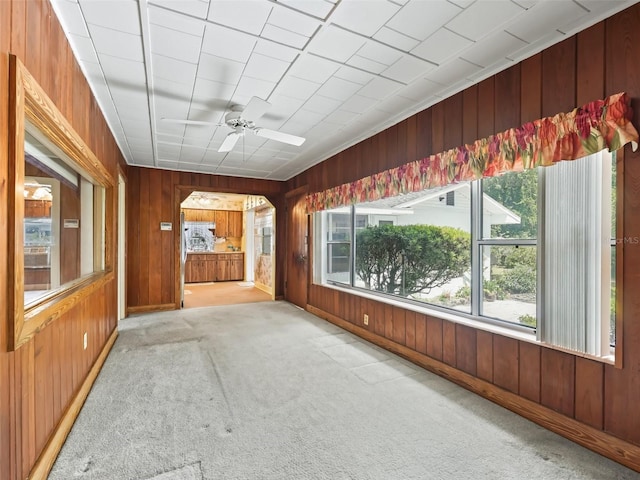 unfurnished sunroom with ceiling fan