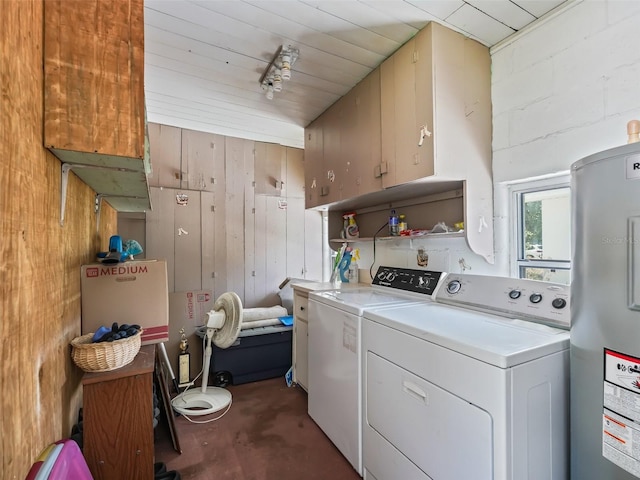 laundry area with independent washer and dryer, wood walls, water heater, and cabinets