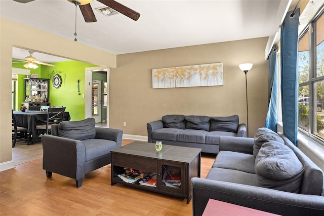 living room with wood-type flooring and ceiling fan