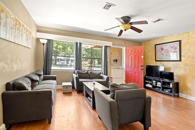 living room with light hardwood / wood-style flooring and ceiling fan