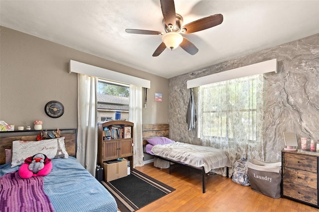 bedroom featuring wood-type flooring and ceiling fan